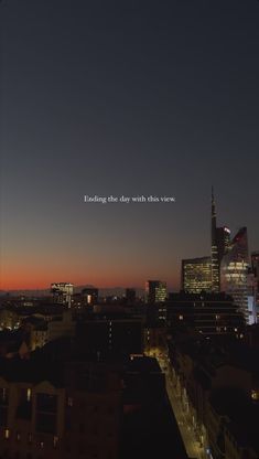 the city skyline is lit up at night with an inspirational quote written in the sky