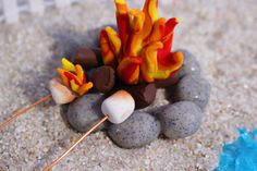 a small campfire made out of rocks on the ground