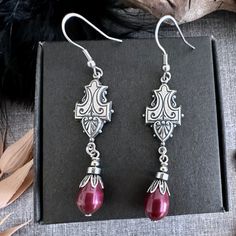 Art Deco vintage style earrings with a Swarovski Burgundy pearl drop. The Silver Art Deco components are sterling silver plated brass that are made in USA and are excellent quality. I have used a Swarovski Burgundy pearl, a bead cap and non magnetic hematite bead for the drop. Earring hooks are stainless steel. They are great for sensitive ears and are all nickel and lead free. Total drop of this earring is  70mm or 3 inches, measured from the top of the earring hook. There is a picture taken on a standard business card to help gauge the size of the earring.  ♥︎ MADE WITH SWAROVSKI AUSTRIAN PEARLS Pearls made in Austria are simulated pearls, they are man-made with a crystal core. This makes them extremely durable and resistant to perfumes and scratching. The lustrous shimmer is achieved us Earring Art, Retro Earrings, Vintage Style Earrings, Pearl Earring, Hematite Beads, Silver Art, Best Friend Gift, Swarovski Jewelry, Swarovski Pearls