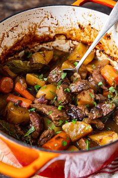 a pot filled with meat and vegetables on top of a table