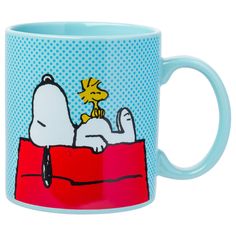 a blue coffee mug with a snoopy dog on it