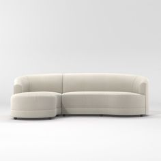 a white couch sitting on top of a white floor