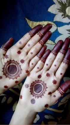 two hands with hendi designs on them