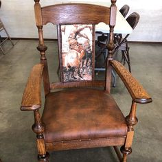 a wooden chair with a painting on the back