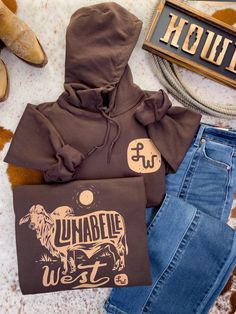 A Lunabelle West Exclusive design Heavyweight Gildan Hoodie with a true to size fit True to size  matching color draw cord front pouch pocket (In Inches) XS S M L XL 2XL 3XL Body Length 26 27 28 29 30 31 32 Chest Width (Laid Flat) 18 20 22 24 26 28 30 Sleeve Length (From Center Back) 32 1/2 33 1/2 34 1/2 35 1/2 36 1/2 Women’s Western Wear, Country Hoodies, Country Boy Outfits, Western Hoodies, Cute Western Outfits, Casual Country Outfits, Country Hoodie, Southern Outfits, Western Wear Outfits