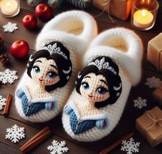 a pair of snow princess slippers sitting on top of a table next to christmas decorations