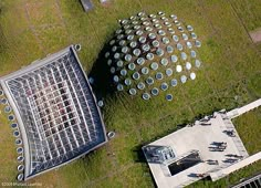 an aerial view of two metal structures in the grass