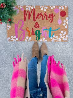 two feet in front of a merry and bright door mat