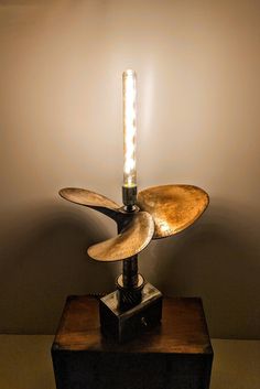 a lamp that is sitting on top of a wooden box with a light bulb in it