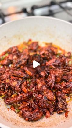 a frying pan filled with lots of food on top of a stove burner