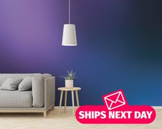 a living room with a couch, table and lamp next to a purple painted wall