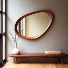 a wooden table with a vase and mirror on it