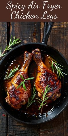 two chicken legs in a skillet with rosemary sprigs on top and the words spicy air fryer chicken legs