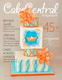 the cover of cake central magazine with an image of a blue and orange cake on it