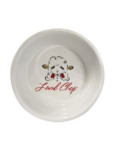 a white bowl with an image of a sheep on the side and red lettering that says,