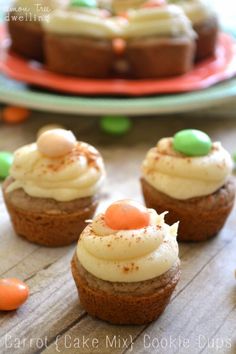 cupcakes with white frosting and candy on top