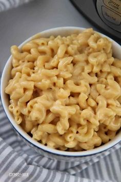 macaroni and cheese in a bowl next to an instant pressure cooker