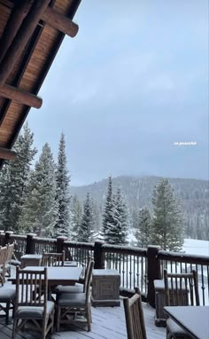 an outdoor deck with chairs and tables covered in snow