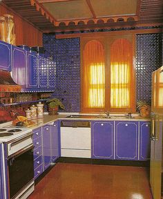 a kitchen with blue and white cabinets and wood flooring is pictured in this image