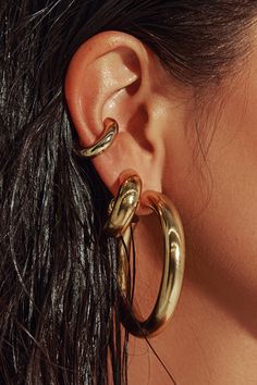 Any outfit, every day, all occasions. Sculpted in a two-inch arc, our 18K gold filled hoops are the style that unites true hoop girls and those who just dabble in the art. Wear solo or alongside other hoops in a graduating stack. Jewelry Collection Handcrafted in Brazil 18k Gold Filled Thickness: 7mm Diameter: 2" Weight: 0.55 oz Waterproof Hypoallergenic Gold Hoop Earring Stack, Stack Jewelry, Chunky Gold Earrings, Chunky Gold Jewelry, Dope Jewelry Accessories, Earring Stack, Xmas Wishlist, Thick Hoop Earrings, Earrings Aesthetic