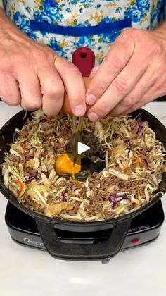 a person cooking food in a skillet on top of a stove