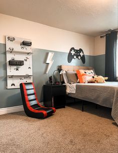 a bed room with a neatly made bed and a game controller on the wall