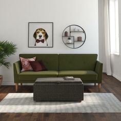 a living room with a couch, coffee table and pictures on the wall