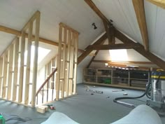 an attic with wood framing and tools on the floor