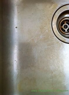 a stainless steel sink with a drain in the middle and no faucet on it