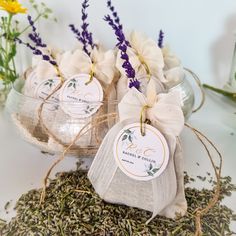 three small bags filled with lavender flowers on top of a table