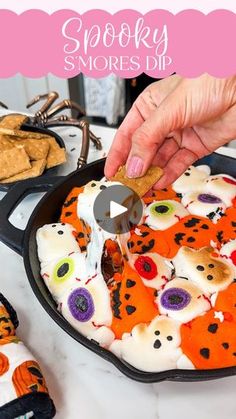 someone is decorating their halloween cookies with fake eyes