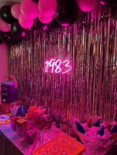 an image of a party setting with balloons and confetti on the table in front of it