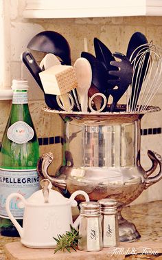 kitchen utensils in a metal pot on a counter