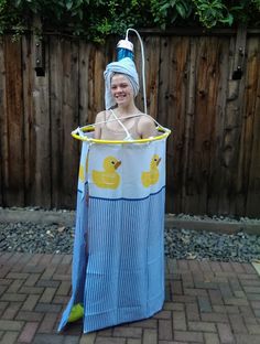 a woman in a blue and yellow bathing suit with a rubber ducky on her head