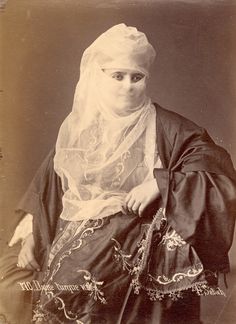 an old photo of a woman wearing a veil