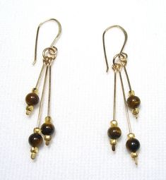 These earrings are Tiger's Eye Their overall length including earwires is about 2". The tiger's eye stones are 4 mm. They are Gold Filled. Handmade by us.  Lyn's Jewelry, in business operating out of Sunny Syracuse since 1989. Tiger Eye Earrings Jewelry, Tigers Eye Jewelry, Pretty Trinkets, Cute Diy Ideas, Dr Belongings, Eye Drop, Artisan Jewelry Earrings, Tiger Eye Earrings, Tiger Eye Jewelry