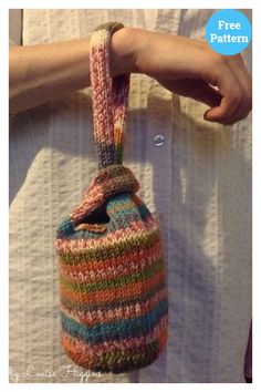 a person is holding a bag made out of yarn and knitted in different colors