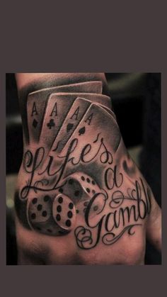 a man's hand with some dice on it and words written in black ink