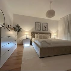 a bedroom with a large bed and white walls