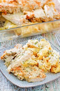 a plate with chicken and pasta casserole on it next to a glass dish