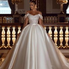 a woman in a wedding dress standing on a balcony