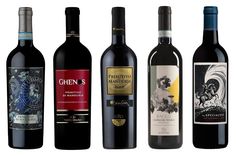 four bottles of red wine are lined up in a row on a white background,