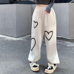 Stay cozy and stylish in our Heart Printed Sweatpants. Made from a soft and comfortable fabric, these sweatpants are perfect for lounging around the house or running errands. The playful heart print adds a touch of fun to your athleisure look. Featuring a drawstring waist and elastic cuffs, these sweatpants are designed for a customized and secure fit. Available in a range of sizes, these sweatpants are a must-have for anyone looking to add a pop of personality to their casual wardrobe. Hip Hop Cargo Pants, Baggy Pants Women, Streetwear Sweatpants, Hip Hop Women, Hip Hop Pants, Baggy Streetwear, Women Cargo Pants, Baggy Sweatpants, Streetwear Hip Hop