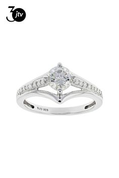 a white gold ring with diamonds on the band and a square cut diamond in the center