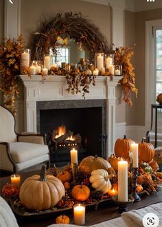 a living room filled with lots of candles and pumpkins on top of a table