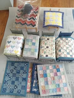 there are many different quilts on the table