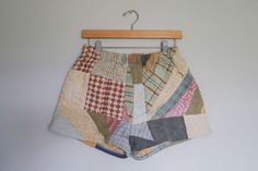 a pair of multicolored shorts hanging on a clothes hanger