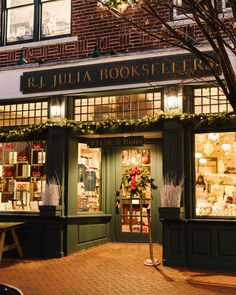 the outside of a book store with christmas decorations on it's windows and lights