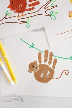 three handprints on white paper with yellow marker and pencil next to one that has an image of a monkey