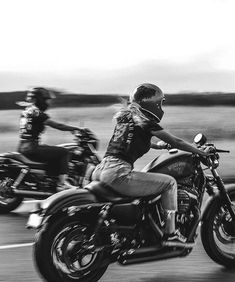 black and white photograph of two people riding motorcycles